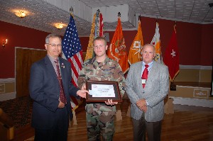 Joe Yavorsky (l), chapter president, and Bob Forrester (r), General Dynamics C4 Systems, present the annual LTG Douglas Buchholz Memorial Scholarship to Staff Sgt. Richard Jackson, USAF, at the April membership luncheon.